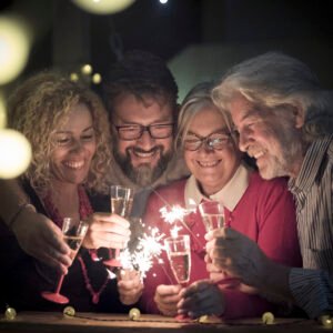 group two seniors two adults together having fun with sparlers new year celebrate happy family with lights midnight